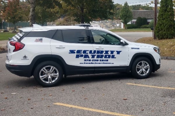 Image of a security patrol vehicle in a parking lot.